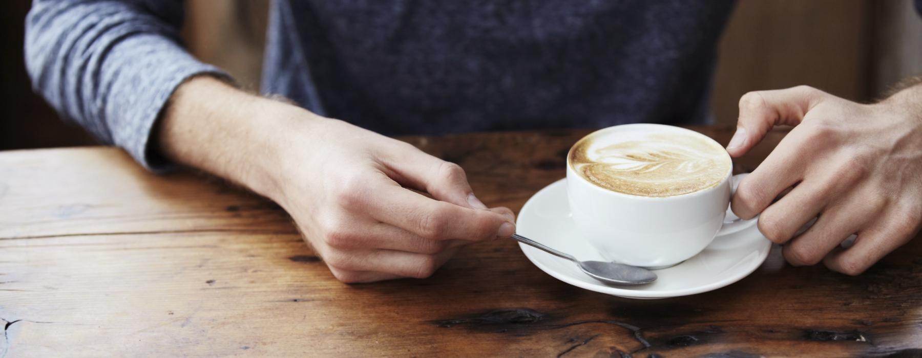 a person holding a cup of coffee