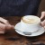 a person with a coffee cup and spoon